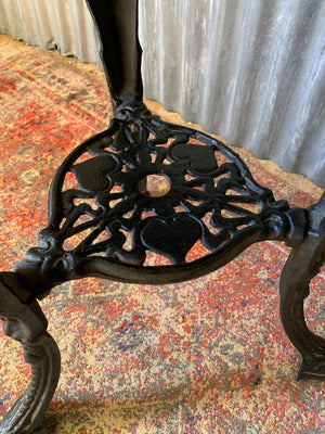 A cast iron Britannia garden table with oak top