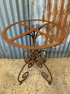 A cast iron garden table with marble top