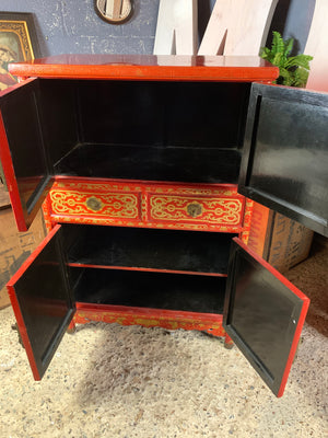 A red and gold lacquer Chinoiserie cabinet