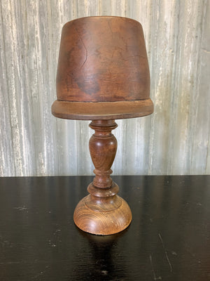 A wooden millinery kepi hat form