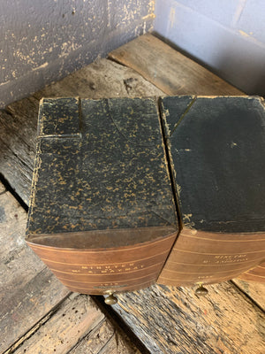 A set of three brown leather and brass book boxes