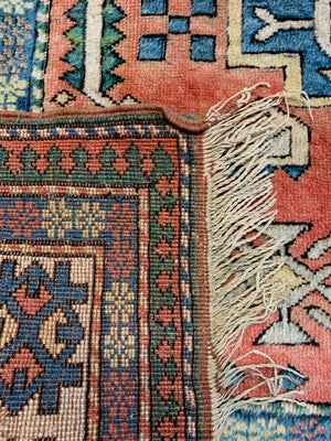 An orange and blue rectangular Persian rug