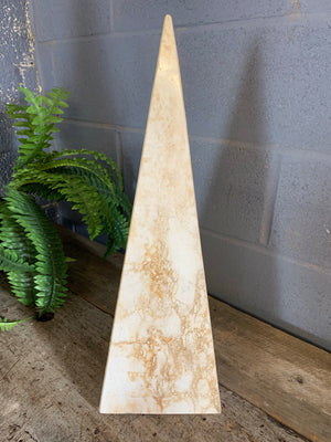 A pair of very large travertine obelisks