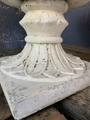 A pair of acanthus pattern cast stone urns