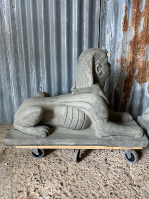 A pair of large cast stone Sphinx statues