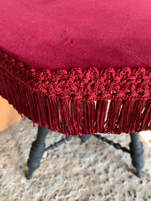 A wooden bobbin gypsy table with red velvet top