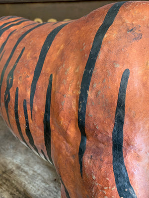 A large vintage leather tiger footstool