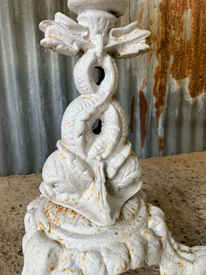 A dolphin base cast iron garden table with marble top