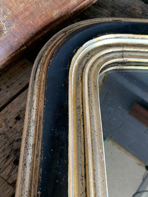 A large ebonised black and gilt overmantle mirror