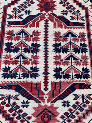 A red and cream ground rug - 195cm x 112cm