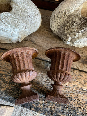 A pair of small cast iron campana urns