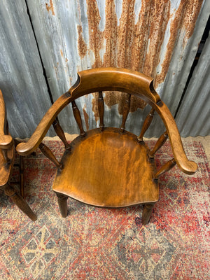 A pair of bow back captain's chairs