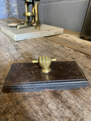 A Victorian brass and cast iron clenched fist paperweight