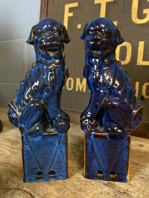A pair of dark blue ceramic Chinese foo dogs