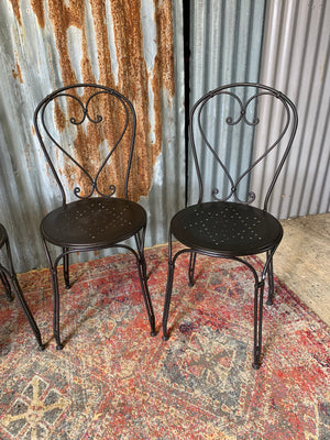 A black marble garden table and four chairs