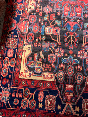 A very large rectangular red ground Persian rug
