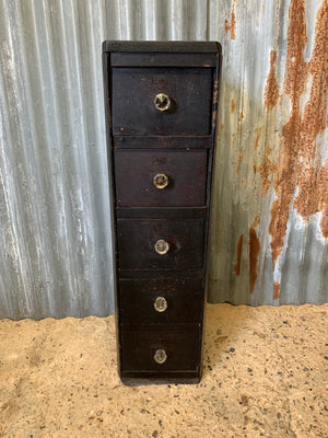A tall bank of five ebonised apothecary drawers