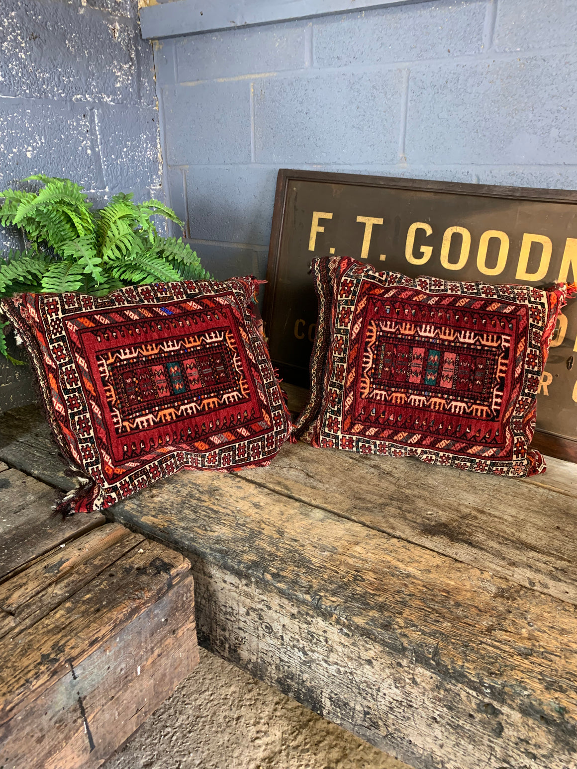 A large pair of red ground Persian carpet cushions