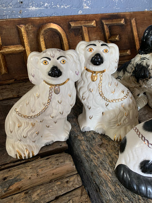 A collection of four pairs of Staffordshire and Beswick fire dogs