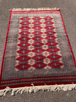 A large hand woven Jaldar red ground rectangular rug - pure virgin wool