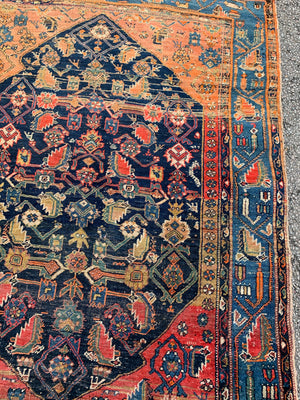 A Persian rectangular rug - red/blue/yellow tones
