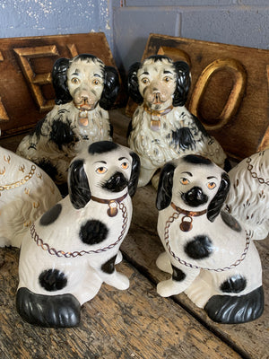 A collection of four pairs of Staffordshire and Beswick fire dogs