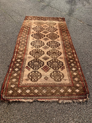 A large rectangular brown ground Persian rug