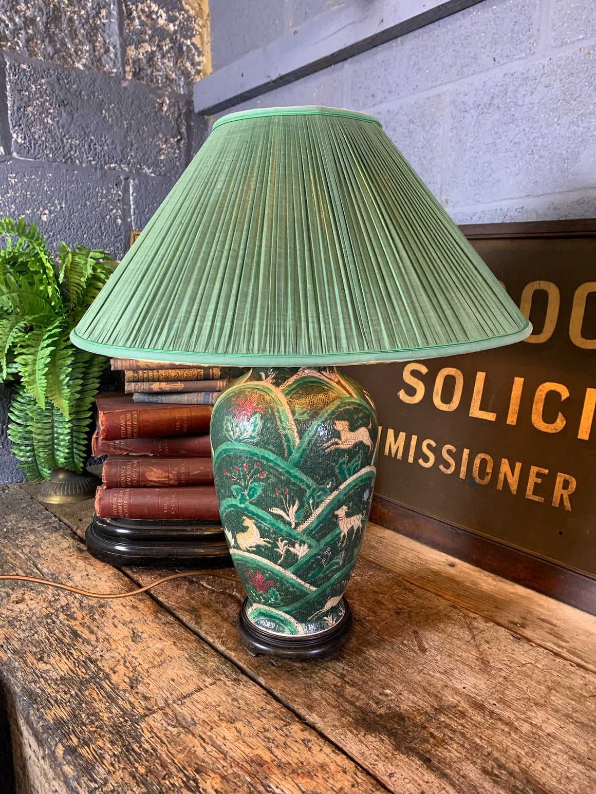 An Oriental green ceramic lamp on a hardwood stand