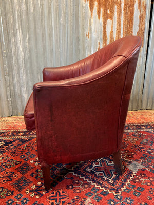 An oxblood leather tub chair