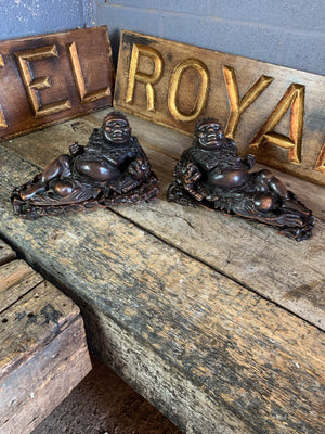 An opposing pair of hand carved reclining buddhas in rosewood