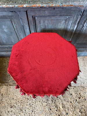 An octagonal red velvet faux bamboo gypsy table