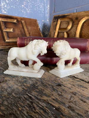 An opposing pair of Grand Tour alabaster Medici lions