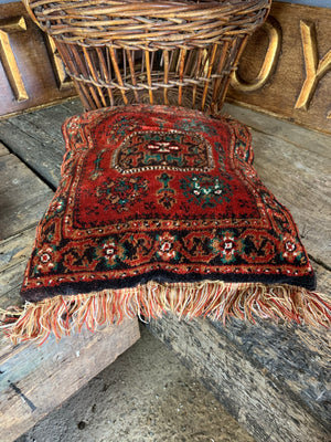 A large red ground Persian carpet cushion - 50cm