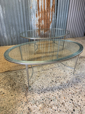 A large oval steel and glass coffee table by Pierre-Yves Rochon