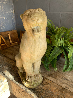 A large weathered cast stone panther statue (62cm)
