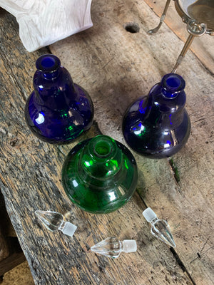 A trio of coloured glass apothecary jars