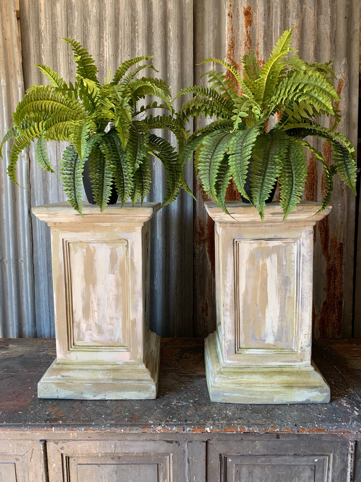 A pair of white pedestal stands