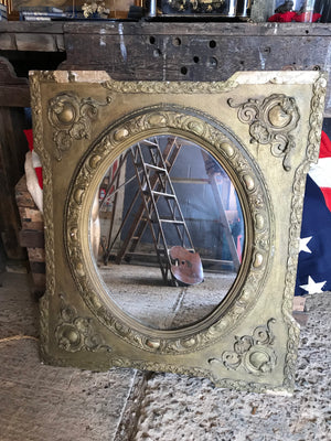 An ornate French rectangular gilt mirror with oval plate