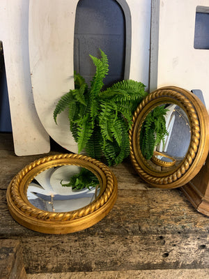 A pair of large gold convex mirrors with rope twist detailing