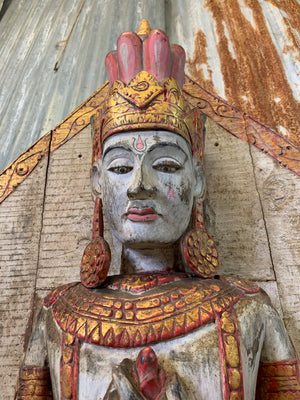 A large carved wooden Brahma figure
