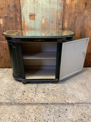 An ebonised credenza with mirrored top