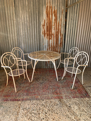 A white metal table and four chairs garden set