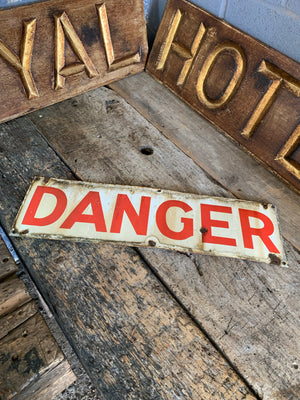 A red and white enamel DANGER sign
