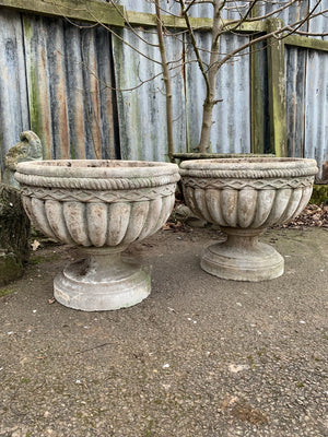 A pair of large cast stone urns