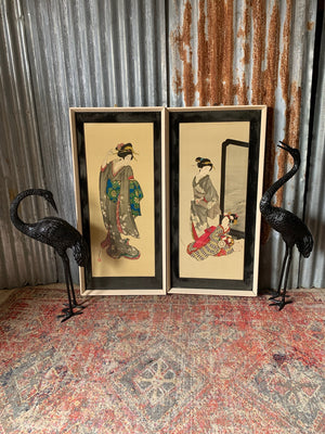 A pair of framed Japanese geisha pictures