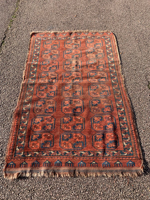 A Persian brown ground rectangular Bokhara rug