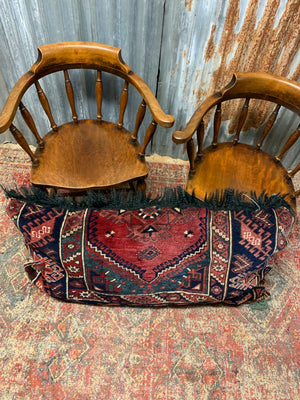 A large rectangular Persian carpet floor cushion