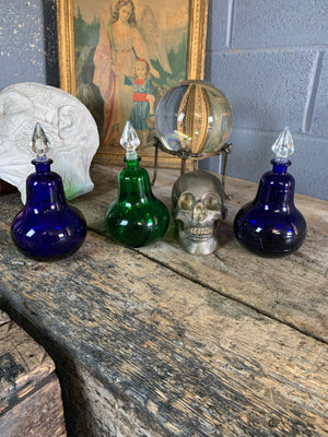 A trio of coloured glass apothecary jars