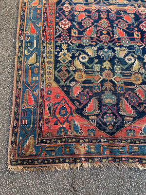 A Persian rectangular rug - red/blue/yellow tones