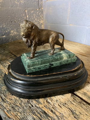 A bronze lion on marble base after Barye